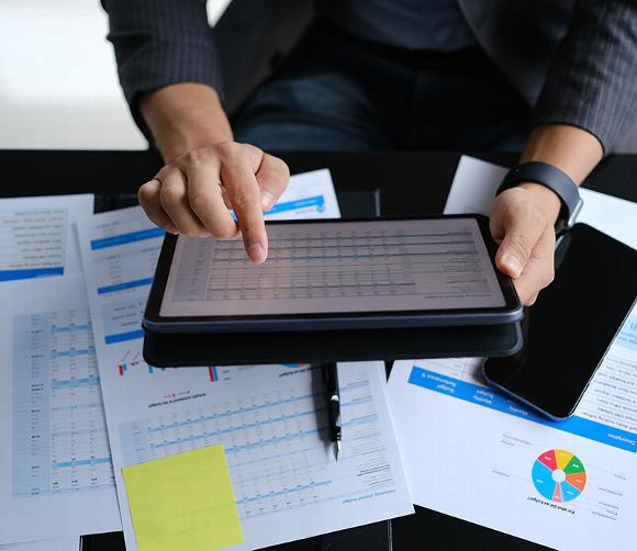 man on tablet looking at pricing tables